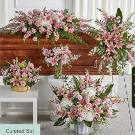 Pink floral funeral set with lilies, roses, and carnations in multiple arrangements