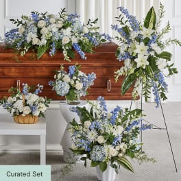 Blue and white floral funeral set with casket spray, standing spray, and vase arrangements