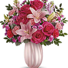 Pink rose and lily bouquet in a pale pink vase