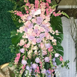 Tall pastel floral standing arrangement with roses and cascading blooms