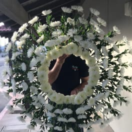 Large white floral wreath with a circular center opening