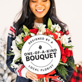 Woman holding a bouquet of red and white flowers with a round sign