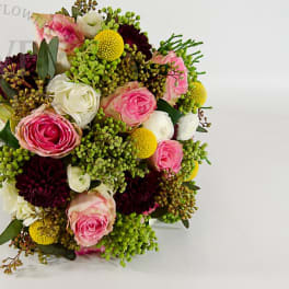 Mixed bouquet of pink, white, and burgundy flowers with green accents