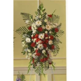 Tall red and white floral standing spray on an easel
