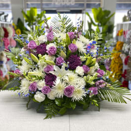 Lavender roses and white lilies in a low floral arrangement