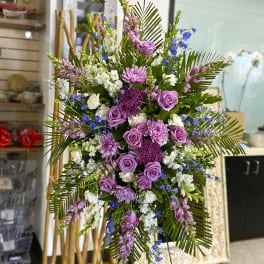 Tall floral spray with purple roses, chrysanthemums, and blue accents