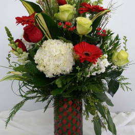 Red and white floral arrangement in a patterned vase