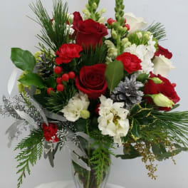 Red and white flower arrangement in a clear glass vase
