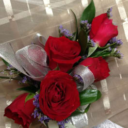 Bouquet of red roses with purple filler and silver ribbon wrap
