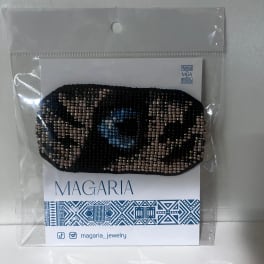 Beaded black hair accessory in plastic packaging