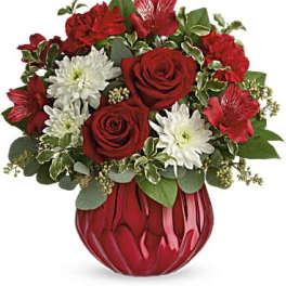 Red roses and white daisies in a red glass vase