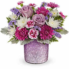 Bouquet of pink and lavender flowers in a glittery vase