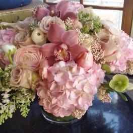 Pink and cream floral arrangement in a glass vase