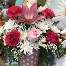 Pink and white mixed bouquet in a polka-dot container