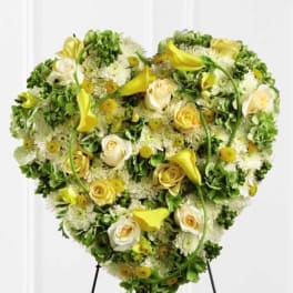 Heart-shaped floral spray with yellow calla lilies and white roses