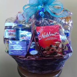 Gift basket with assorted snacks and a blue ribbon bow