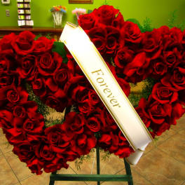 Heart-shaped red rose wreath with a white "Forever" ribbon