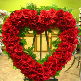 Heart-shaped red rose standing spray on an easel