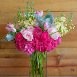 Pink and white bouquet in a clear rectangular vase