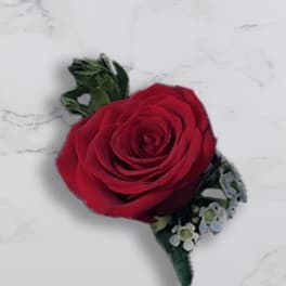 Red rose boutonniere with small blue-white accent flowers