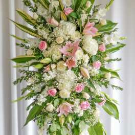 Tall standing floral spray with pink and white lilies and roses