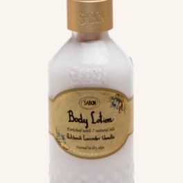 Bottle of Sabon body lotion with a gold pump dispenser