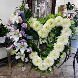 Two floral heart wreaths with white mums, lavender roses, and lilies