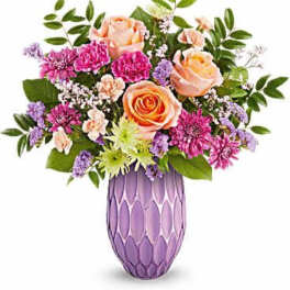Peach roses and purple flowers in a lavender vase