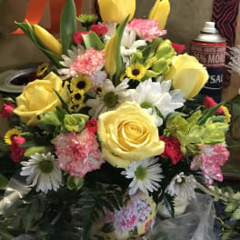 Mixed bouquet of yellow roses, daisies, carnations, and tulips