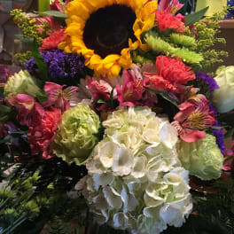 Bright mixed bouquet with a large sunflower and white hydrangeas