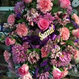 Pink and purple floral wreath with roses and ribbon