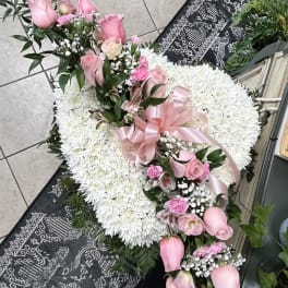 Heart-shaped white chrysanthemum wreath with pink roses and ribbon