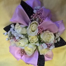 Bouquet of cream roses with pink and black ribbon accents