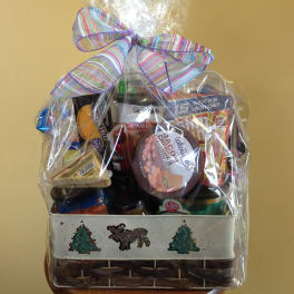 Gift basket of assorted snacks wrapped in clear cellophane with a striped bow