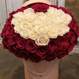 Heart-shaped bouquet of red and white roses in a pink hatbox