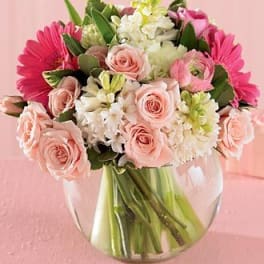 Pink and white mixed bouquet in a clear glass vase