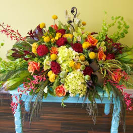 Colorful mixed flower arrangement on a blue table