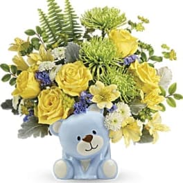 Yellow flower bouquet in a blue teddy bear vase