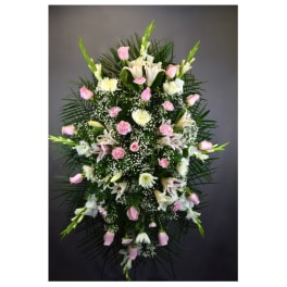 Tall standing floral spray with pink and white flowers on a dark background