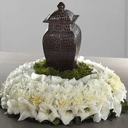 White floral wreath around a dark decorative lantern centerpiece