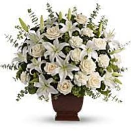 White floral arrangement in a brown urn vase