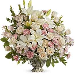 White lilies and pale roses in a decorative vase