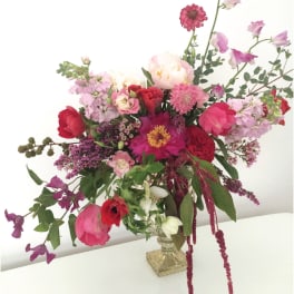 Mixed pink and red flower arrangement in a clear glass vase