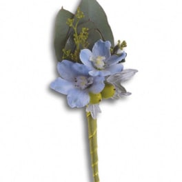 Blue flower boutonniere with dark leaves and a wrapped stem
