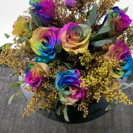 Bouquet of rainbow-colored roses with yellow filler flowers