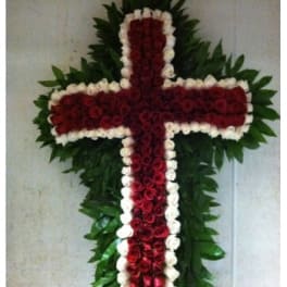 Cross-shaped floral arrangement of red and white roses