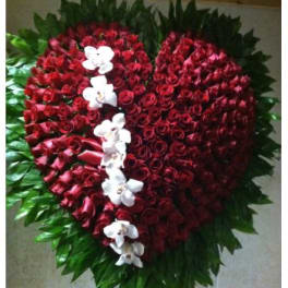 Heart-shaped red rose arrangement with white orchids and green foliage
