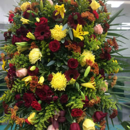 Large mixed floral spray with red, yellow, and peach blooms