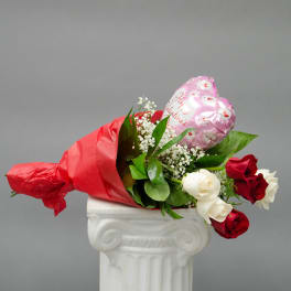 Bouquet of red and white roses with a pink heart balloon