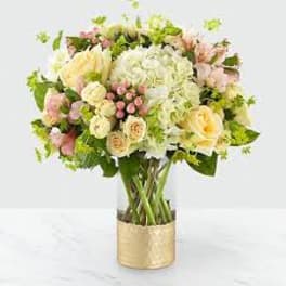 Bouquet of pastel flowers in a gold vase